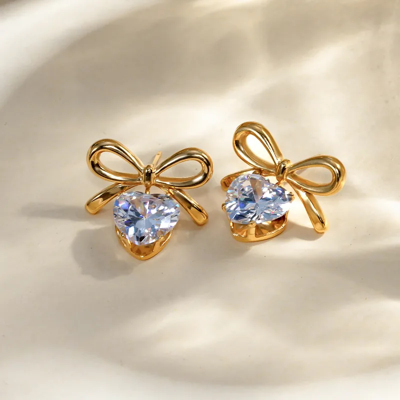 Solitaire heart and bow earrings