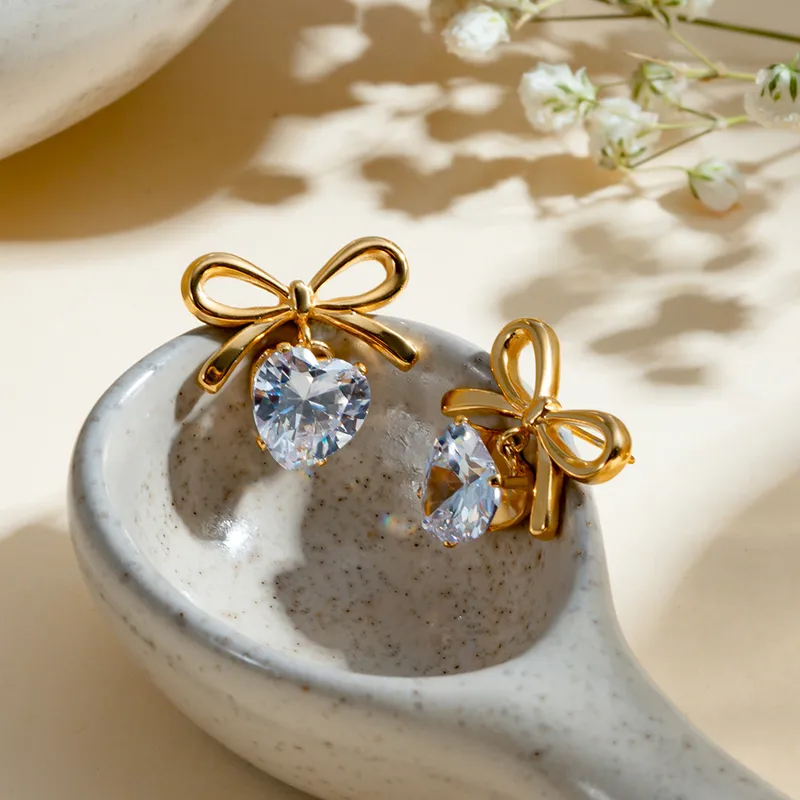 Solitaire heart and bow earrings
