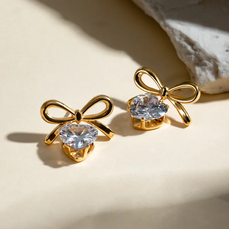 Solitaire heart and bow earrings
